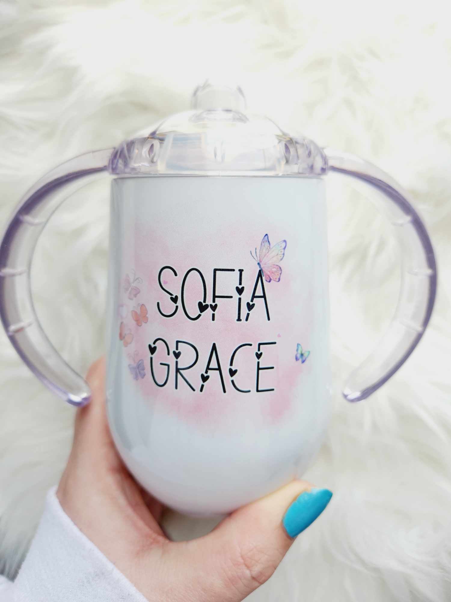 White sippy cup with child's first and middle name surrounded by purple and pink butterflies
