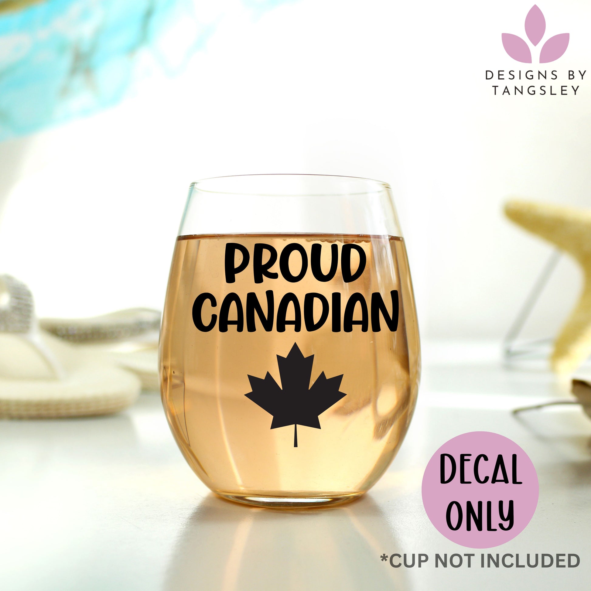 black PROUD CANADIAN decal on a glass wine glass with a maple leaf