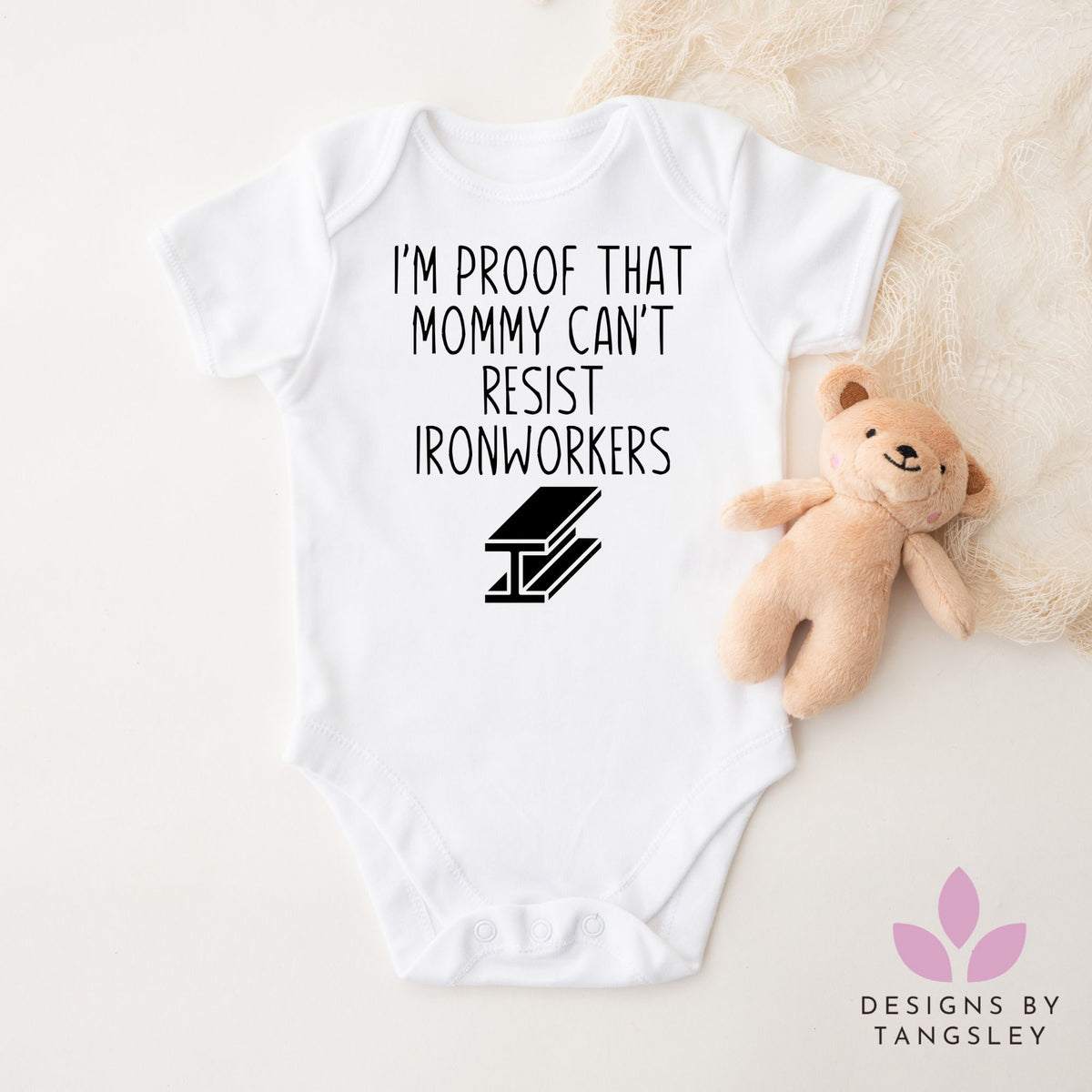 White short sleeve baby bodysuit that says IM PROOF THAT MOMMY CAN'T RESIST IRONWORKERS