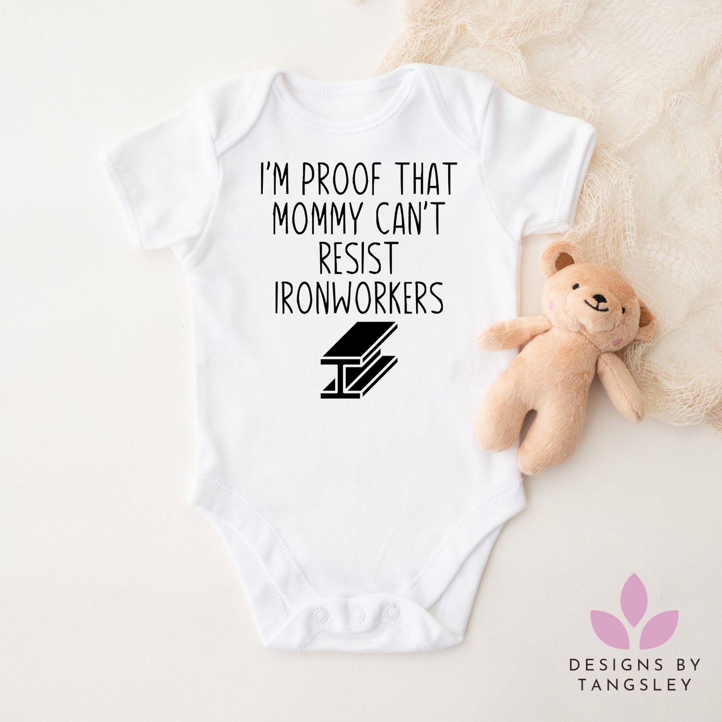 White short sleeve baby bodysuit that says IM PROOF THAT MOMMY CAN'T RESIST IRONWORKERS