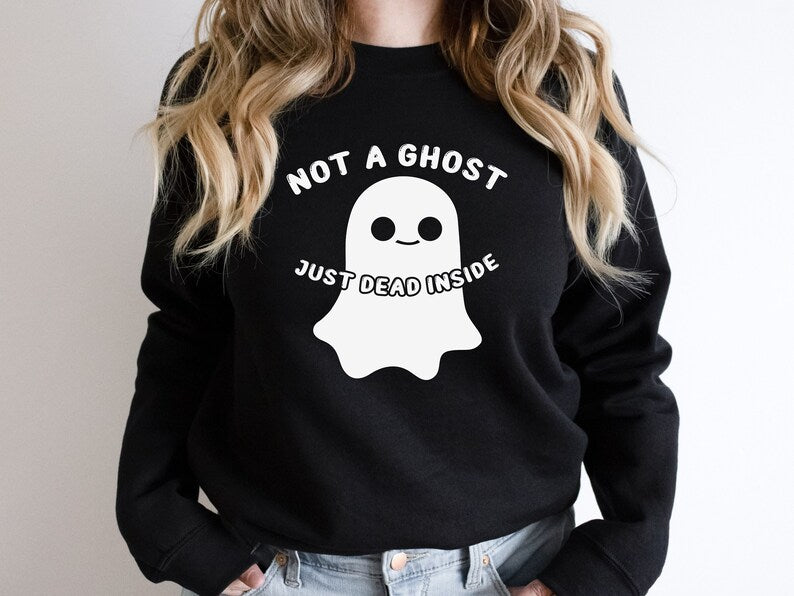 Black crewneck sweater that has a cute ghost on it with "NOT A GHOST JUST DEAD INSIDE" in white