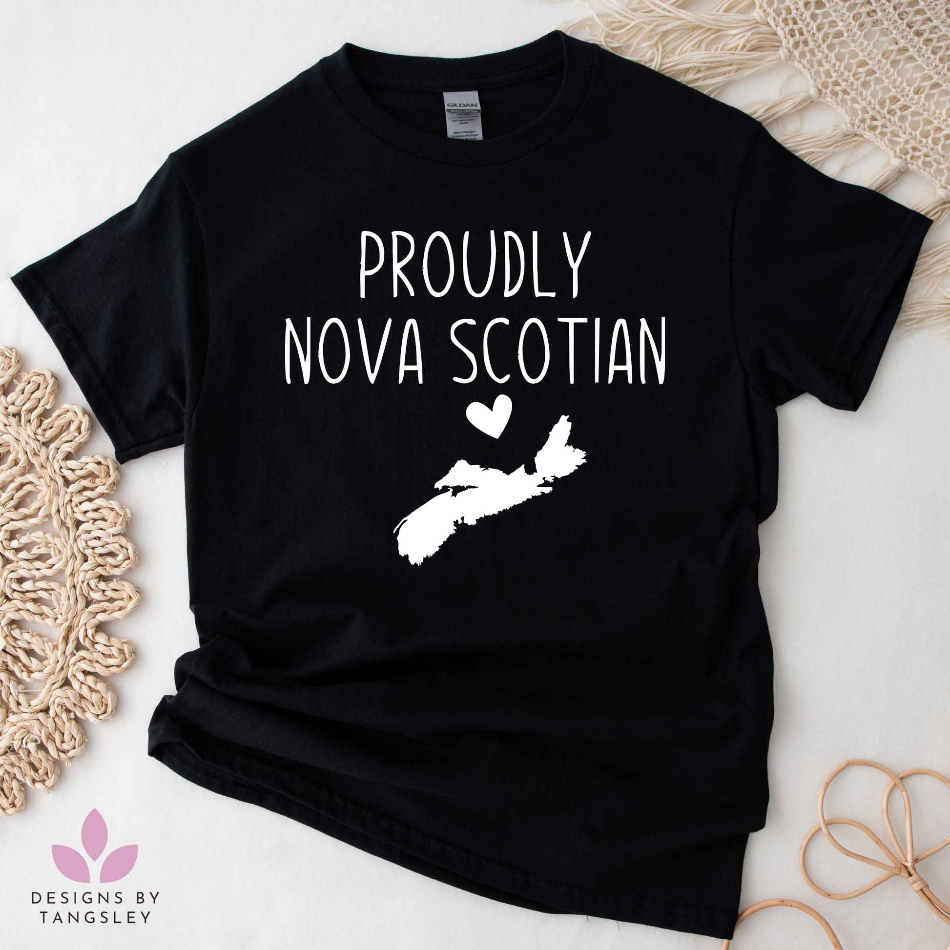 Black t-shirt that says "PROUDLY NOVA SCOTIAN" with an image of Nova Scotia and a heart above it.