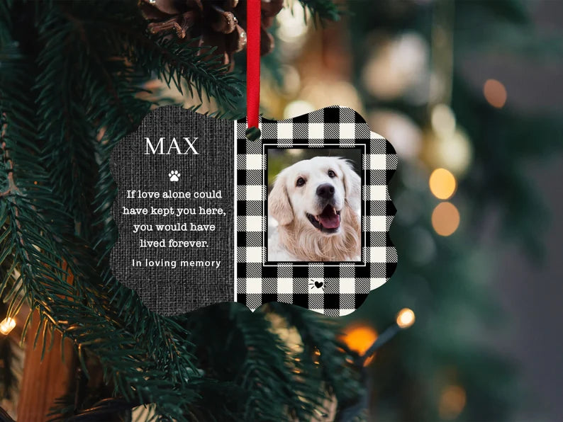 black and white plaid ornament with pet image on it and name. It says if love alone could have kept you here you would have lived forever with a little paw print. And it said in loving memory at the bottom.