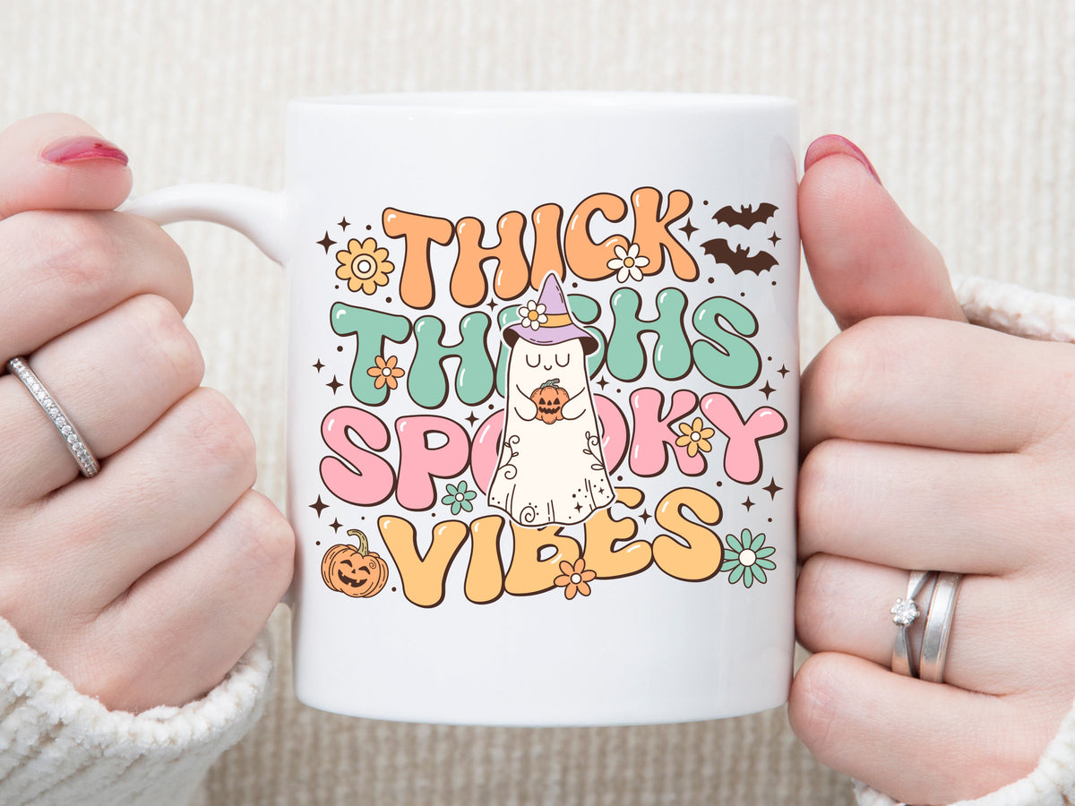 Thick thighs and spooky vibes coffee mugs - Designs by Tangsley