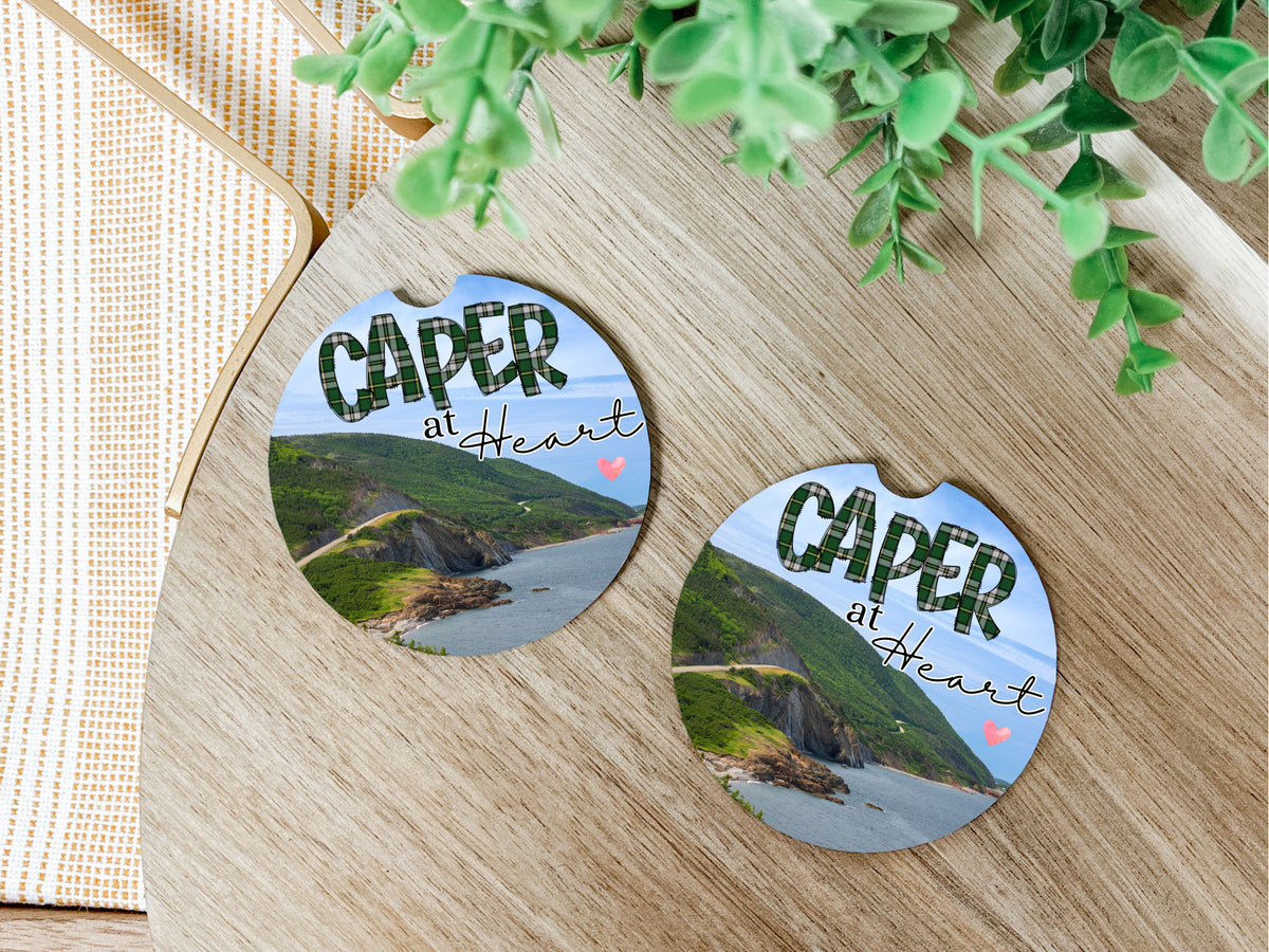 Caper at heart soft car coasters for vehicle cup holders. It has a picture of the lookoff of Cape Breton.