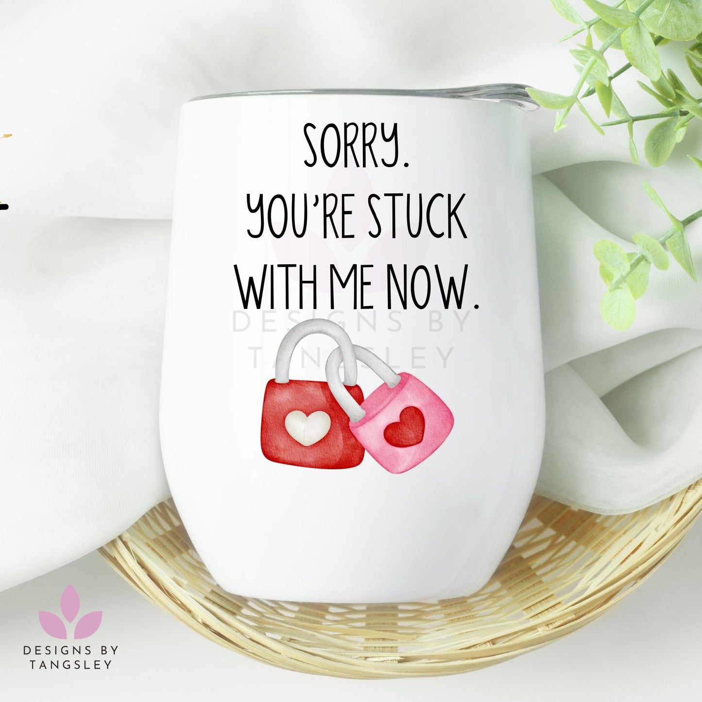 Wine tumbler with plastic lid. It says "Sorry you're stuck with me now." with two locks locked together. One pink and one red.