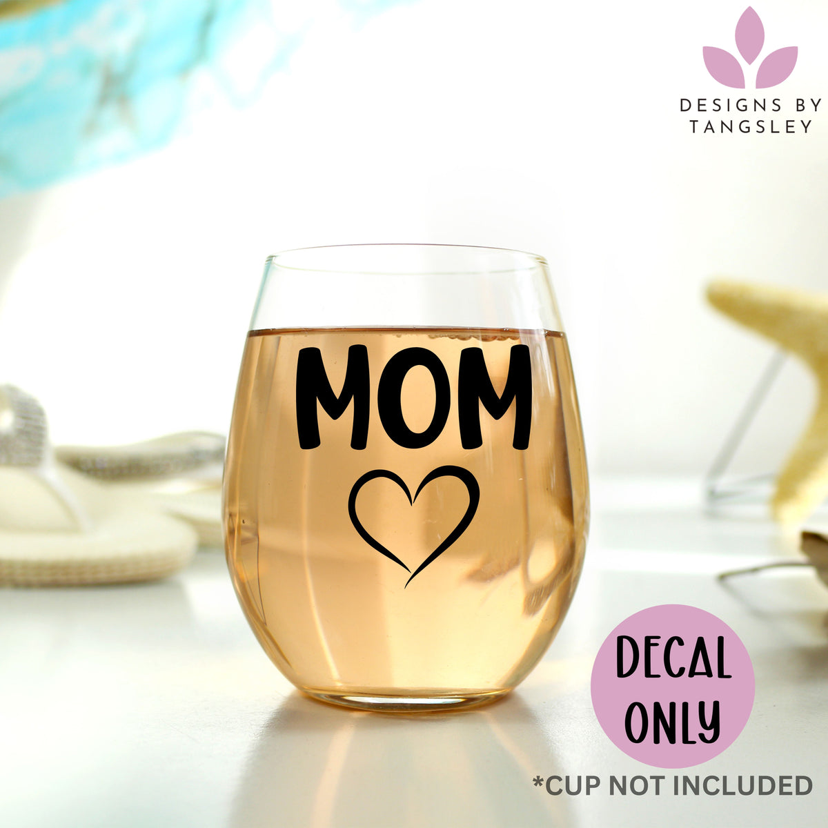 MOM decal with a heart below it pictured on a wine glass.