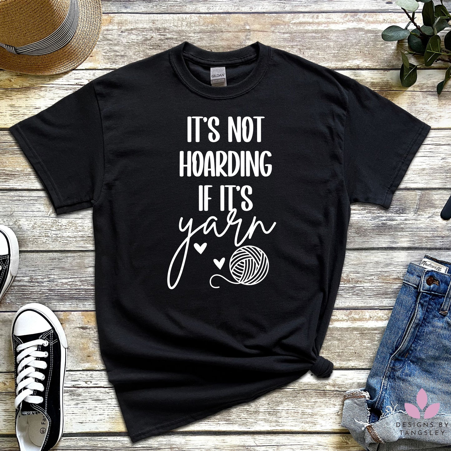 black t-shirt with "IT'S NOT HOARDING IF IT'S yarn" in white with a ball of yarn and two hearts 