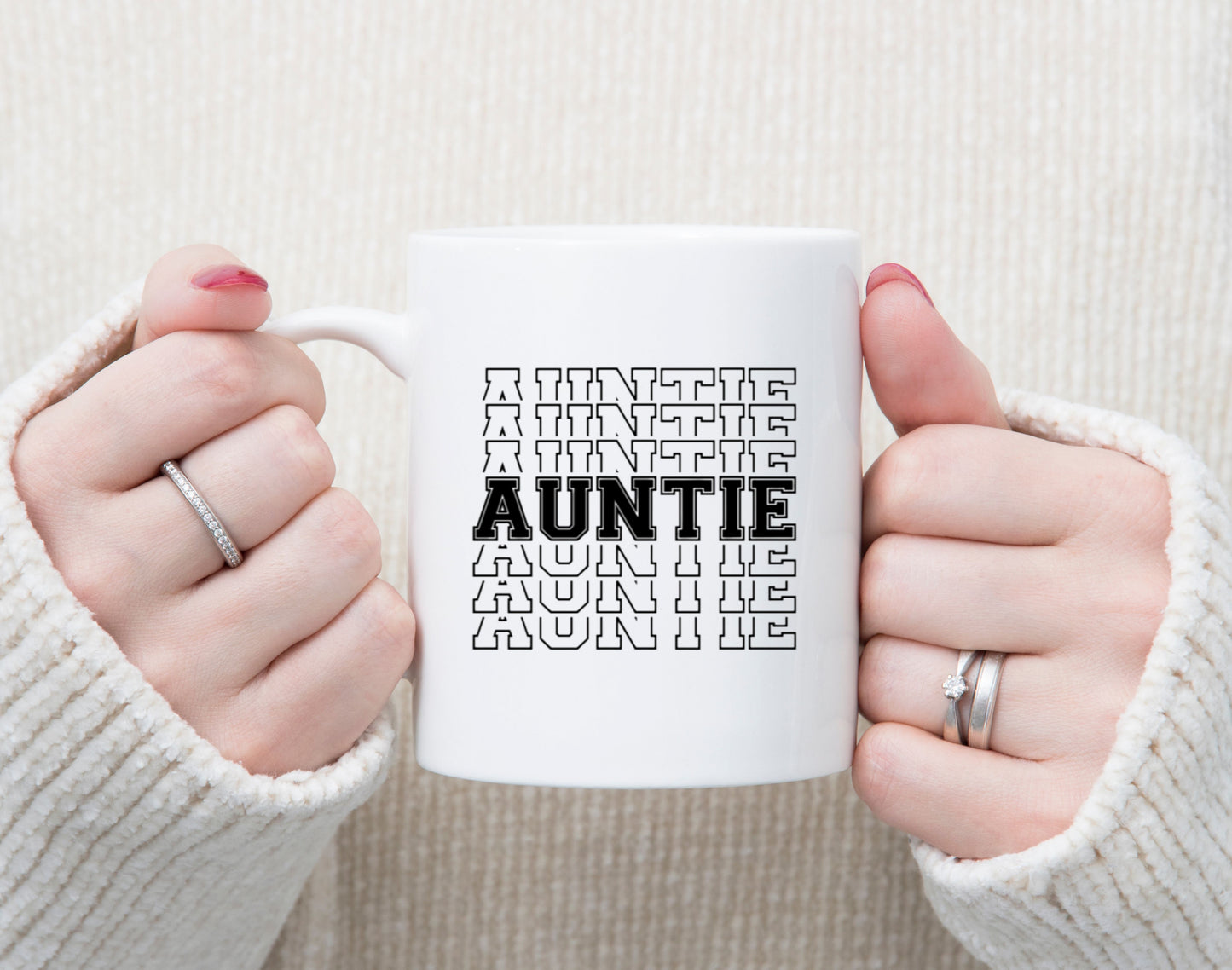 White coffee mug with AUNTIE in a varsity style font. The design is stacked.