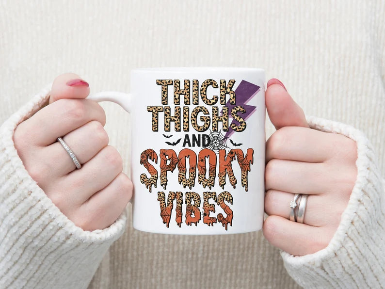 Thick thighs and spooky vibes coffee mugs - Designs by Tangsley